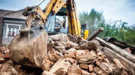 Hydraulic crusher excavator backoe machinery working on site demolition